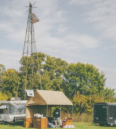 Man making kettle corn in front of a windmill