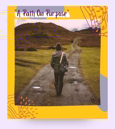 A woman standing on a path in the outdoors.