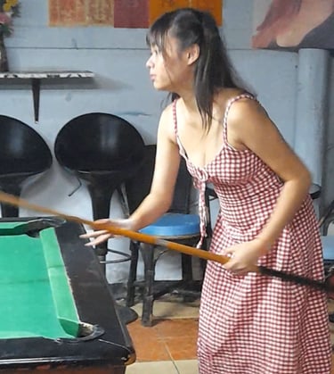 Thai woman playing pool at Nees Tiki Club, Hua Hin