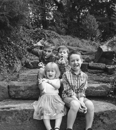 a group of children sitting on some steps