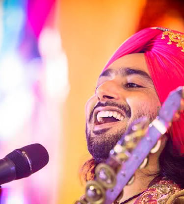 a man in a turban with a microphone and a microphone