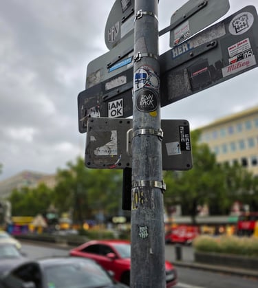 a street sign with stickers on it