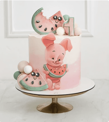 a cake with a piggy and a watermelon