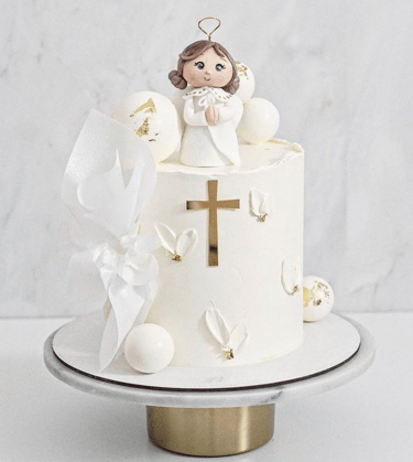 a cake with a little angel on top of it