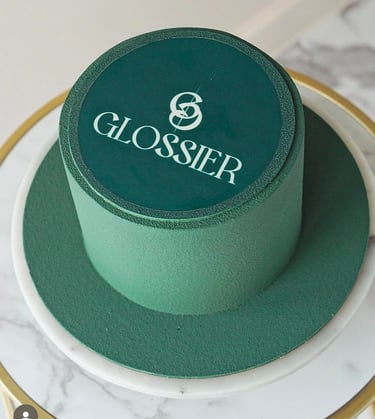 a cake with a green hat on top of a table
