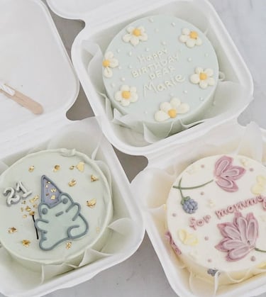 a birthday cake in a container with a unicorn birthday cake