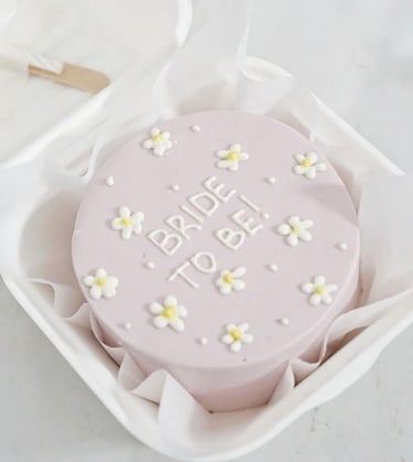 a cake with a bridesmaid cake topper