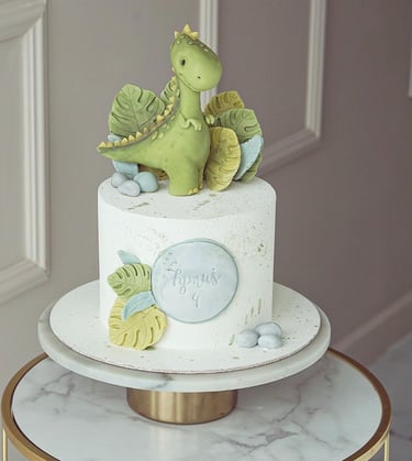 a cake with a dinosaur on top of a table