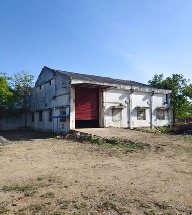 a warehouse with a red shutter door and a red door