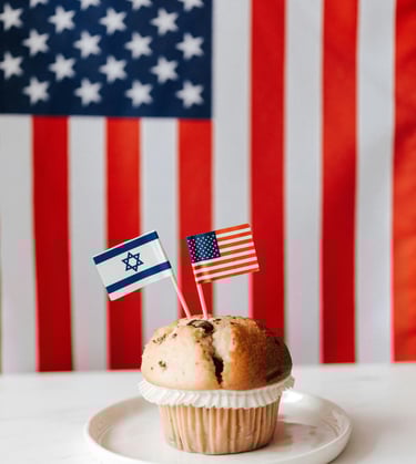 Photo of a muffin with tiny US and Israel flag on toothpicks