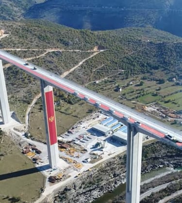 Aerial view of Moracica Bridge with flag of Montenegro Highway