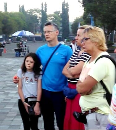 a group of people standing in brief around a group of european client