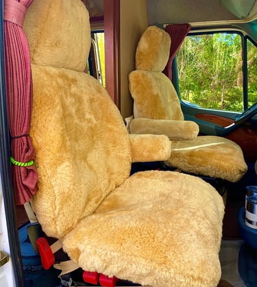 Plush tan sheepskin seat covers installed on motorhome captain chairs for luxury comfort.