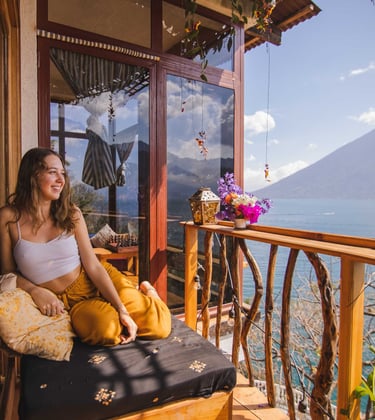Bask in the warmth of the morning sun with a breathtaking view of Lake Atitlán, where every sunrise.