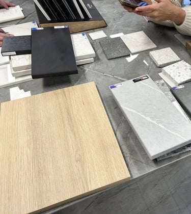 a customer looks at samples of quartz and stone laid out on an island