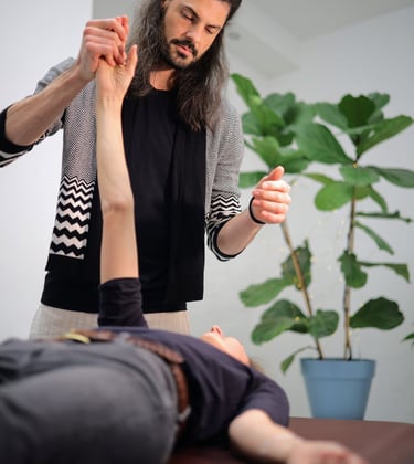 practitioner moving clients outstretched arm to change neurons through inactive movement
