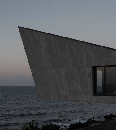 An architectural photography of a sharp-edged modernist villa overlooking a calm, dark ocean at dusk. Muted grey tones, deep black textures, and soft cinematic lighting. North American / International.