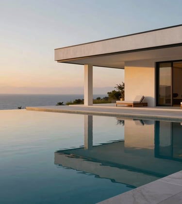 A minimalist infinity pool at dusk. The water is perfectly still, reflecting a white and pure black modern pavilion. Soft warm gold lighting emanates from the building. North American / International setting, serene and quiet atmosphere.