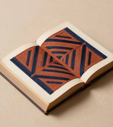 An open antique book on a clean sand-colored surface, its pages adorned with terracotta and deep navy embroidery creating an abstract geometric pattern. Professional studio lighting with soft, editorial shadows.