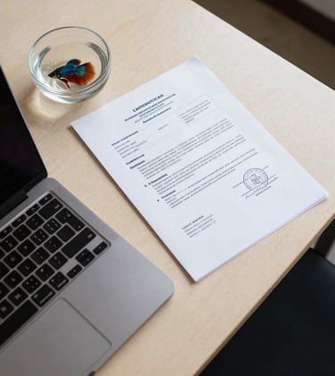 A top-down workspace shot in a Southeast Asian / Filipino office. A Crisp Parchment colored desk holds a laptop, official customs documents, and a small glass bowl with a vibrant betta fish. Professional and organized setting.