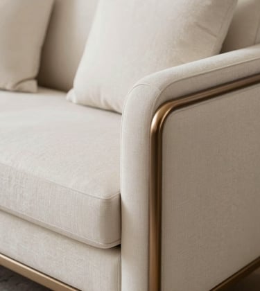 Detailed shot of artisanal custom furniture and high-end decor elements. Handcrafted textures, soft bronze accents, and elegant fabrics in a neutral cream and white palette. Minimalist and luxurious composition.