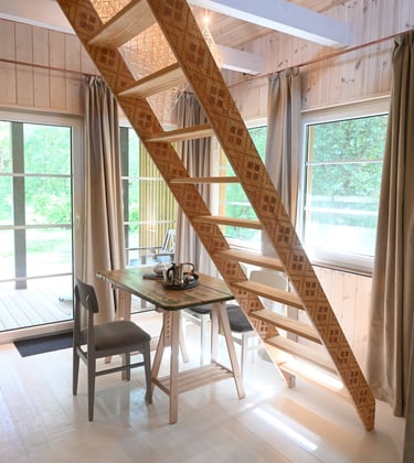a wooden staircase leading to a lofted room