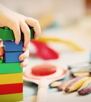 Un enfant joue avec des lego qu''il superpose