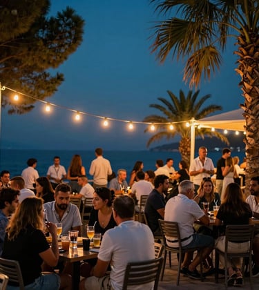 Photography of a lively evening social gathering for the Turkish Riviera / European expat and tourist community. People are sitting at outdoor tables, enjoying cold drinks under glowing string lights with warm sunset orange accents. The background features deep pine teal night sky and tropical palms.