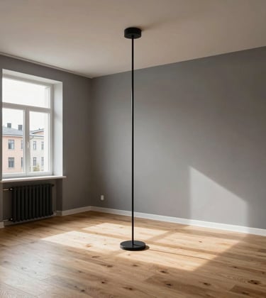 Interior photography of a premium renovated apartment in a Northern European city. Minimalist living room with warm grey walls, light oak flooring, and high-end black metal light fixtures. The space is filled with natural light.