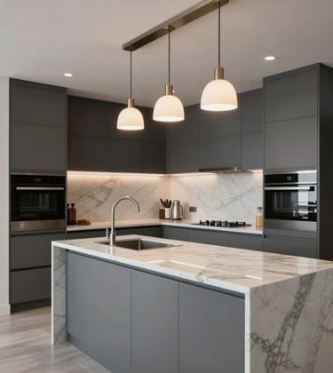 Professional photography of a newly renovated apartment interior. Focus on a sleek, handle-less kitchen in graphite grey and white marble countertops, illuminated by designer pendant lights.