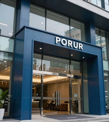 Close-up architectural photography of a high-end commercial entrance near Porur, featuring sleek glass and steel blue metal finishes. The lighting is crisp and professional, emphasizing a modern business environment.