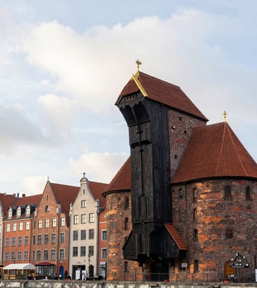 A beautiful shot of the historical timber crane and brick architecture of the old Gdansk port, captured in the soft cloud white light of morning.