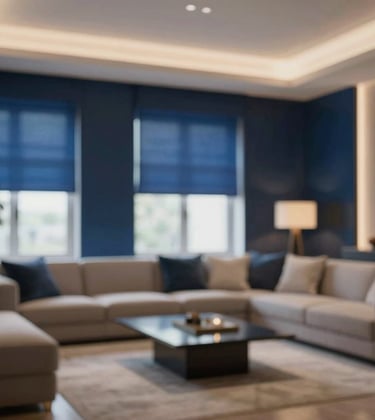 A sophisticated living room with intelligent lighting and shading. Sheer motorized shades are partially lowered, and warm royal blue (#0F1A2B) accents highlight the architectural details of the room.