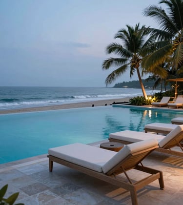 A luxurious infinity pool overlooking a tropical coastline in South Asia / India during the blue hour, elegant off-white lounge chairs, soft ambient lighting.