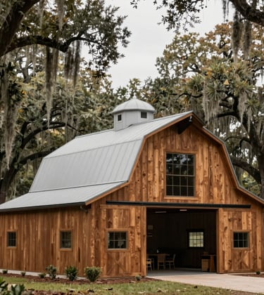 A professional architectural photography shot of a clean and modern barn on a North American / US farm. The structure features Cedar Brown wood accents and stands beautifully against a backdrop of ancient live oaks draped in Spanish moss. The lighting is crisp and natural, highlighting the rustic yet modern design of the ranch.