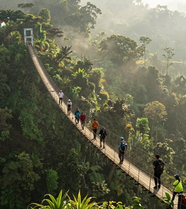 An adventurous shot of the long suspension bridge at Sukabumi, hanging over a lush valley with deep forest green vegetation and misty ivory air. A group of Southeast Asian / Indonesian hikers are crossing the bridge under soft morning sunlight.