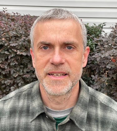 Arthur, the owner wearing a gray-green flannel shirt.