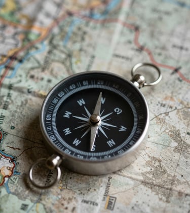A minimalist photograph of a high-end compass on a weathered map, captured with soft professional lighting and deep contrast.