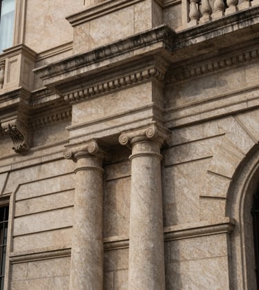 Close-up detail of a classical stone facade in the Eixample district of Barcelona, representing stability and legacy. Soft shadows, elegant textures, high-end architectural photography. Southern European setting.