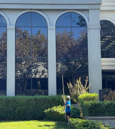 a man is cleaning a lawn in front of a building