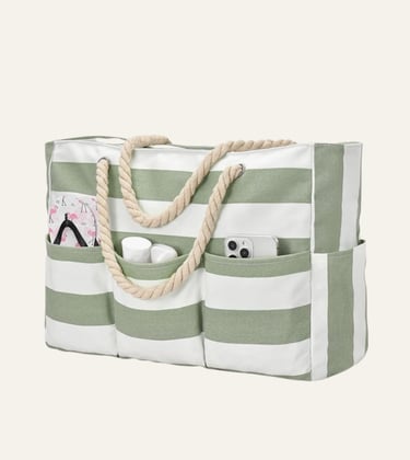 Large green and white striped canvas beach tote bag with rope handles and exterior pockets.