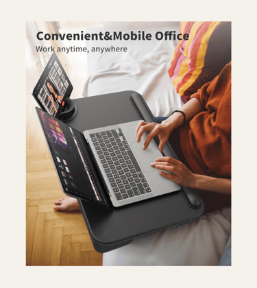 picture of a woman's lap with a black lap desk a n open laptop and tablet on the side
