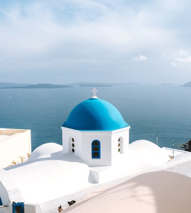 a blue dome shaped building with a blue dome shaped building in Greece