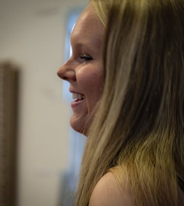 Side profile of a happy blonde woman with long hair smiling at her Senior Party Athens Ohio
