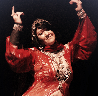 Shahravar Egyptian style bellydancer wearing red assuit fabric. Traditional folk dress with silver.