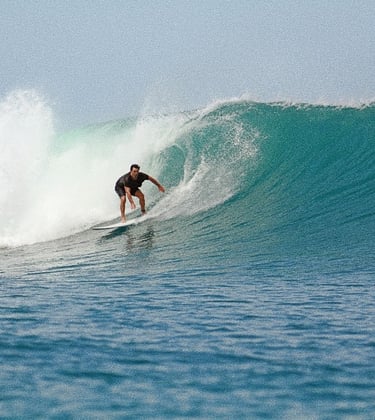 a man riding a wave in the ocean with his friend 