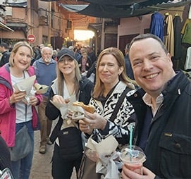 a group of people tasting street food