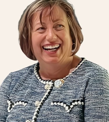 The head and shoulders of a woman with green eyes and short, light brown hair is smiling.