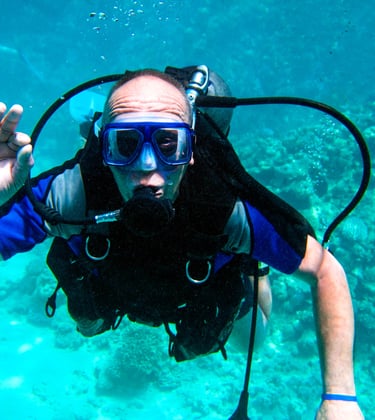a man in a diving suit and goggles in the water