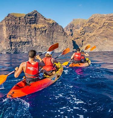 a group of people kayaking in kayaks
